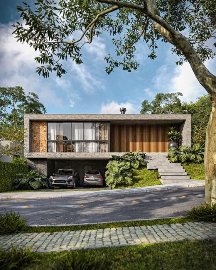 Casa de hormigón sobre un terreno en pendiente, con ventanal, revestimiento de madera y escalera exterior entre plantas